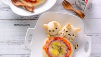 Pizza juga bisa menjadi alternatif untuk bekal si kecil. Shirley membentuk adonan pizza sehingga membentuk dua ekor kucing sebagai pinggiran pizza mini ini. Foto: Instagram/liittlemissbento