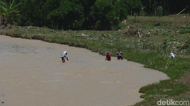 Warga seberangi sungai
