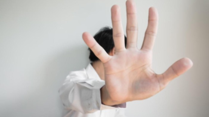 Blurred de focused a man showing palm hand, concept of denial