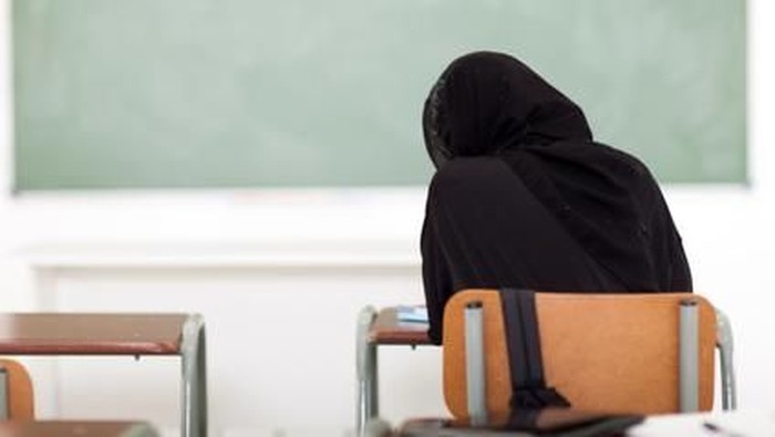 rear view of Arabian school girl in classroom