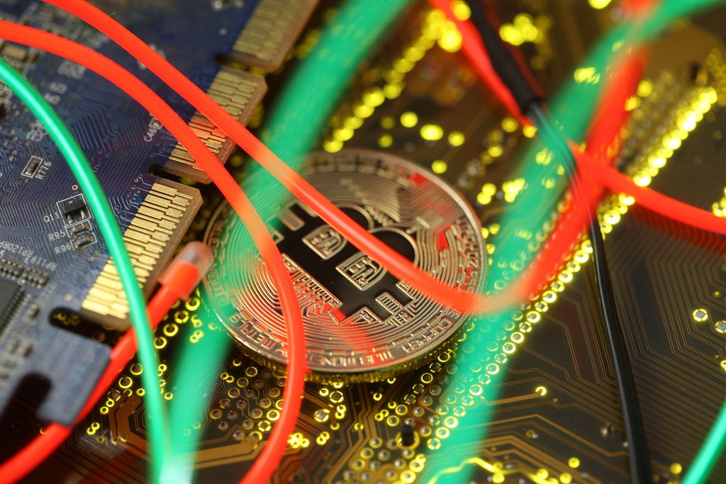 Representation of the Bitcoin virtual currency standing on the PC motherboard is seen in this illustration picture, February 3, 2018. REUTERS/Dado Ruvic/Illustration