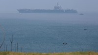 Terlihat USS Carl Vinson berlayar di dekat kapal-kapal nelayan Vietnam. Juru bicara Angkatan Laut AS, Letnan Komandan Tim Hawkins, menyebut kunjungan USS Carl Vinson ke Vietnam ini menandai langkah maju dalam kerja sama yang semakin erat antara kedua negara. Foto: REUTERS/Kham