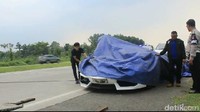 Mobil Lamborghini putih itu ditutup terpal oleh polisi, sebelum diangkut menggunakan mobil derek menuju Pool Cilamari. (Foto: Dian Firmansyah/detikcom)