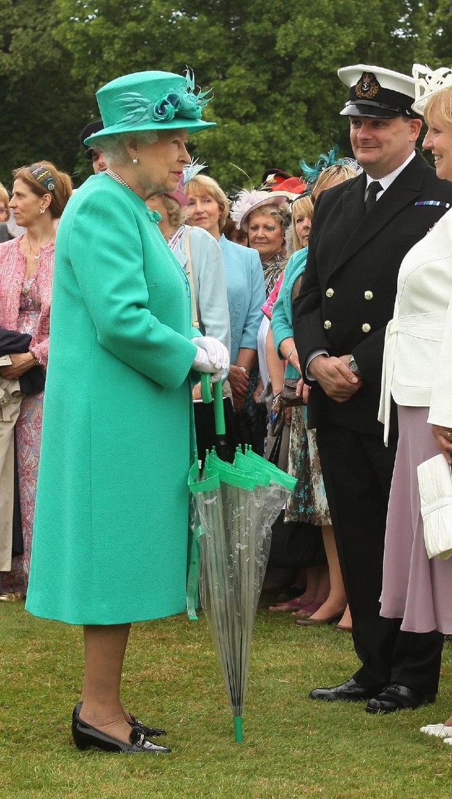 Tidak ketinggalan, payung berwarna hijau yang matching dengan mantelnya. Foto: dok: Getty Images