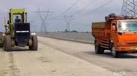 Alat berat dan truk nampak hilir mudik.