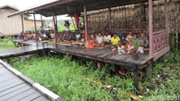 Para ibu-ibu dan anak-anaknya sedang berkumpul di sebuah bangunan yang terlihat seperti saung. Foto: Danang Sugianto/detikFinance