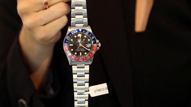 An exhibitor displays the Rolex rare stainless steel dual time automatic wrist watch that was made for Ruler of Dubai Sheikh Mohammed bin Rashid al-Maktoum, at the Christie's auction in Dubai, United Arab Emirates, March 19, 2018. REUTERS/Satish Kumar