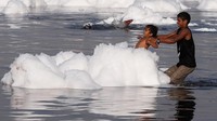 Anak-anak di India bermain busa di sungai Yamuna, India yang tercemar polusi.