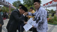 Sugianto memberikan tabungan pensiun kepada guru di Kalimantan Tengah. Tak lupa, dia mencium tangan para pahlawan tanpa tanda jasa tersebut. Foto: dok. Pemprov Kalteng