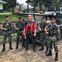 Arnold Putra bahkan pernah melakukan pemotretan bersama para prajurit TNI. Dia memakai busana karya Haider Ackermann saat berpose di antara para tentara dan tank.Foto: Instagram Arnold Putra