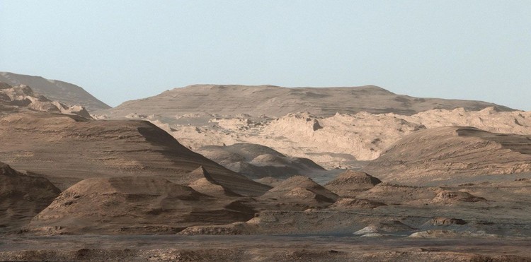 This composite image looking toward the higher regions of Mount Sharp was taken on September 9, 2015, by NASAs Curiosity rover. In the foreground -- about 2 miles (3 kilometers) from the rover -- is a long ridge teeming with hematite, an iron oxide. Just beyond is an undulating plain rich in clay minerals. And just beyond that are a multitude of rounded buttes, all high in sulfate minerals. The changing mineralogy in these layers of Mount Sharp suggests a changing environment in early Mars, though all involve exposure to water billions of years ago. The Curiosity team hopes to be able to explore these diverse areas in the months and years ahead. Further back in the image are striking, light-toned cliffs in rock that may have formed in drier times and now is heavily eroded by winds.

The colors are adjusted so that rocks look approximately as they would if they were on Earth, to help geologists interpret the rocks. This 