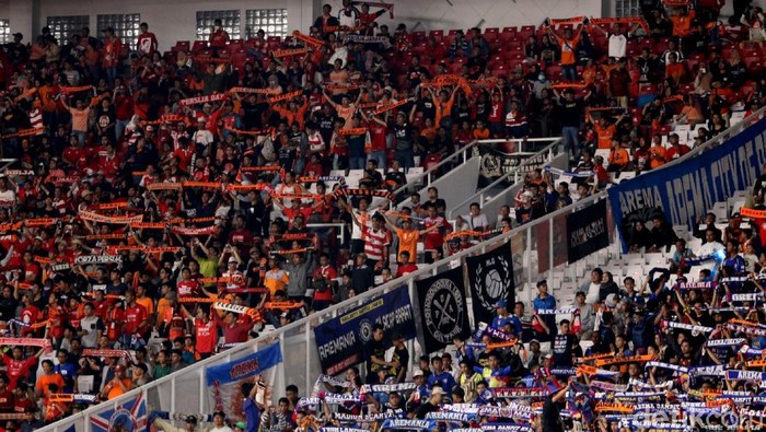 Harmonisme pertandingan Persija vs Arema kental terasa di luar lapangan. Jakmania-Aremania Saling Sahut di GBK. Yuk, intip solidartitas keduanya suporter.