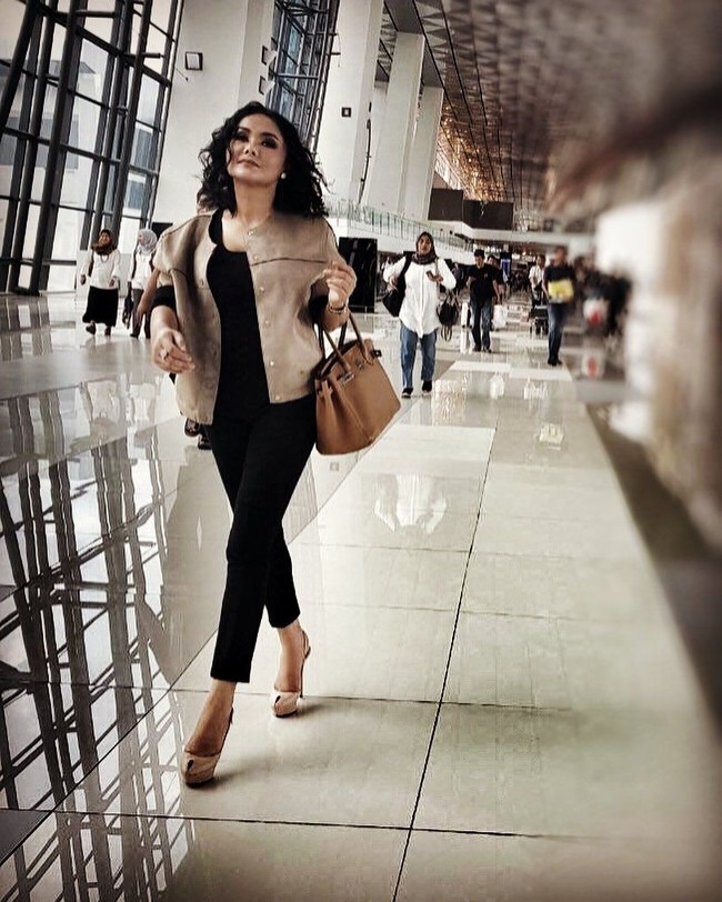 Penyanyi lagu lawas Yuni Shara terlihat tampil dengan nuansa monokrom saat berada di bandara. Memakai jaket cokelat, dia menenteng tas Hermes Birkin 30 cm Gold Togo Hardware seharga US$ 18.750 atau sekitar Rp 258 juta. Foto: Instagram
