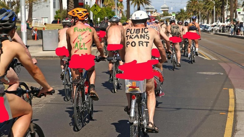 89505282 MELBOURNE, AUSTRALIA - FEBRUARY 28: (EDITORS NOTE: Image contains nudity.) Naked bike riders cycle past St Kilda Beach during the 2016 World Naked Bike Ride on February 28, 2016 in Melbourne, Australia. The World Naked Bike Ride is an annual international clothing-optional bike ride in which participants ride together to peacefully protest issues including body image, cyclists safety and alternative lifestyles. (Photo by Scott Barbour/Getty Images)