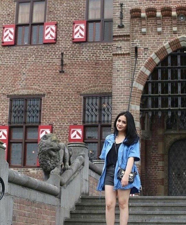 Bergaya casual saat liburan ke Eropa, Nagita Slavina berpose cantik memakai jaket denim dan celana pendek sambil membawa tas Louis Vuitton seri petite malle seharga US$ 5.500 atau sekitar Rp 75,7 juta. Foto: Instagram