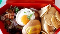 Burger Superman ini berisi patty daging ayam, bacon kalkun, keju dan aneka sayuran. Pendampingnya nachos keju yang renyah. Kress! Foto: dok. detikFood