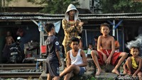 Sejumlah anak bersantai di pinggir rel.