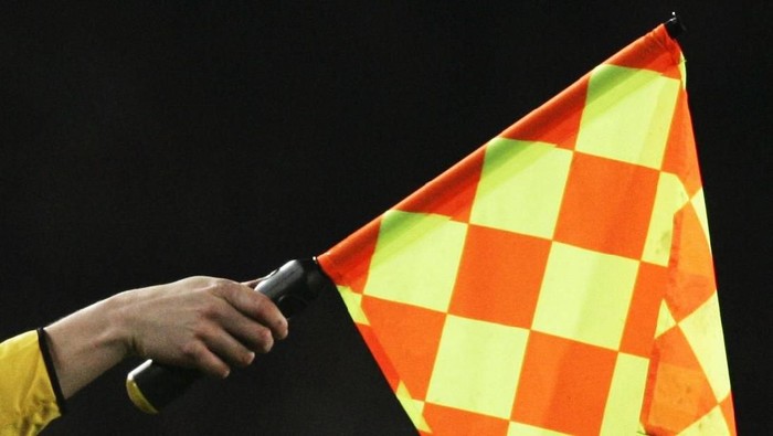 BARCELONA - FEBRUARY 23:  Assistant referee signals for offside during the UEFA Champions League first knock-out round, first leg match between Chelsea and Barcelona at Nou Camp, on 23 February 2005 in Barcelona, Spain.