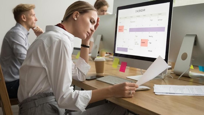 Worried executive reading a letter sitting in a coffee shop