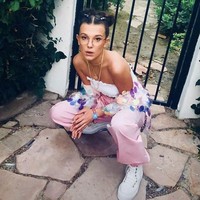 Crop top dan celana warna pastel yang feminin semakin mencuri atensi dengan jaket statement ala Millie Bobby Brown. Foto: Instagram