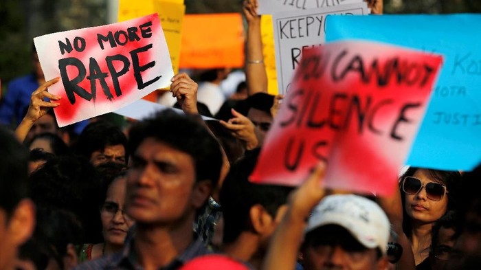 People hold placards as they participate in a protest against the rape of an eight-year-old girl in Kathua near Jammu, and a teenager in Unnao, Uttar Pradesh state, in Mumbai, India, April 15, 2018. REUTERS/Danish Siddiqui