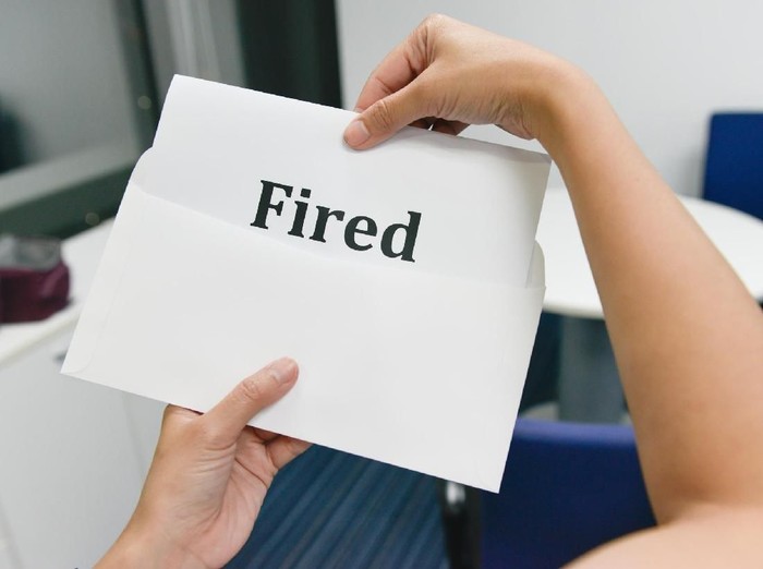 Worried executive reading a letter sitting in a coffee shop