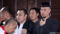 Dhani sebelumnya dilaporkan oleh Jack Boyd Lapian terkait dugaan ujaran kebencian. Jack menyoal cuitan Dhani soal semua penista agama wajib diludahi.