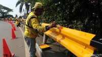 Pekerja mengecat pagar Flyover Senayan, Jakarta Pusat.