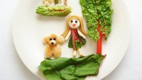  Bikin gemas! Sosok anak perempuan bersama anjingnya ini terbuat dari roti dan sayuran. Kalau dijadikan bekal, si kecil pasti suka. Foto: Instagram @rinonche