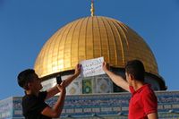 Foto tulisan tangan berlatar Dome of the Rock (Ammar Awad/Reuters)