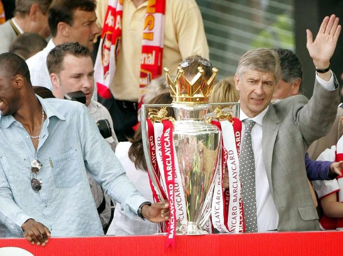 FILE PHOTO: Arsenal's Thierry Henry, Patrick Viera and manager Arsene Wenger celebrate during a victory parade in north London May 16, 2004. Arsenal are celebrating their victory in the English premier league. Arsenal became the first team since Preston North End's 