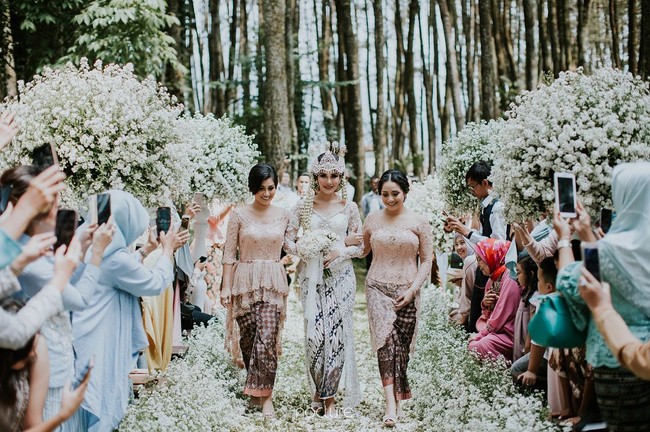 Dekorasi akad lebih dekat dengan nuansa alam dengan penggunaan bunga peacock putih sepanjang altar. Foto: Dok. Instagram/Nocture