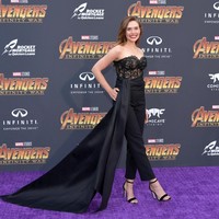 Elizabeth Olsen si pemeran Scarlet Witch tampil memikat dengan jumpsuit hitam rancangan Oscar de la Renta. Bustier berbahan lace serta aksen belt panjang menyapu lantai membuat penampilannya dramatis nan seduktif. Foto: Dok. Getty Images
