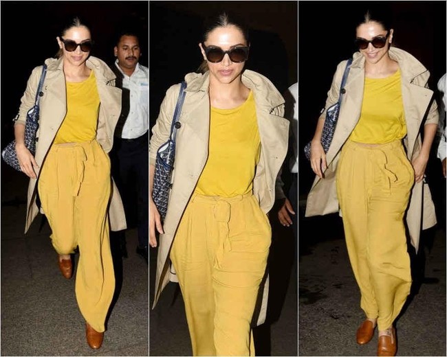Serba kuning menjadi airport style Deepika Padukone. Dia menambagkan trench coat Burberry dan tas Goyard pada penampilannya di bandara Mumbai ini. Foto: Dok. Instagram viralbhayani, Instagram Deepika Padukone FC