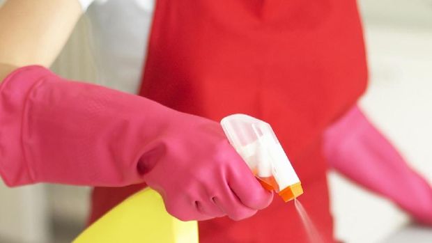 housewife taking out clean dishware from dishwasher at home kitchen