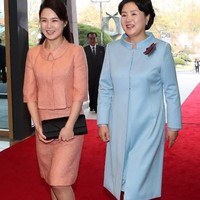Penampilan Ri saat bertemu Ibu Negara Korea Selatan, Kim Jung-sook. Di bulan April 2018 lalu, Ri tampil cantik berbalut setelan warna peach. Ia memilih clutch serta sepatu pump hitam sebagai padanannya. (Foto: AFP)