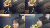 Nyam! Setangkup burger siap masuk ke mulut Suzy. Lihat ekspresinya saat ia bersiap melahap burger tebal ini. Foto: Instagram @baesuzy.sz