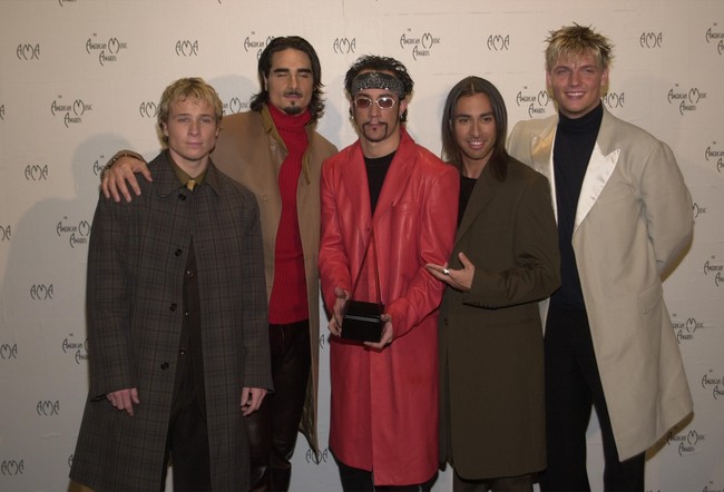 Mantel kebesaran di karpet merah. Tak ketinggalan kacamata kecil sebagai aksesori. Foto: Dok. Getty Images