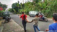 Warga membawa ular jenis piton. Satwa tersebut bikin geger warga Kampung Nyangkokot, Kabupaten Sukabumi, Jawa Barat, Selasa (1/5/2018). (Foto: Syahdan Alamsyah/detikcom)