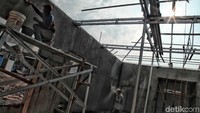 Pekarja menyelesaikan pembangunan tembok musala.