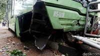 Kondisi bumper bus ringsek menghantam pembatas jalan.