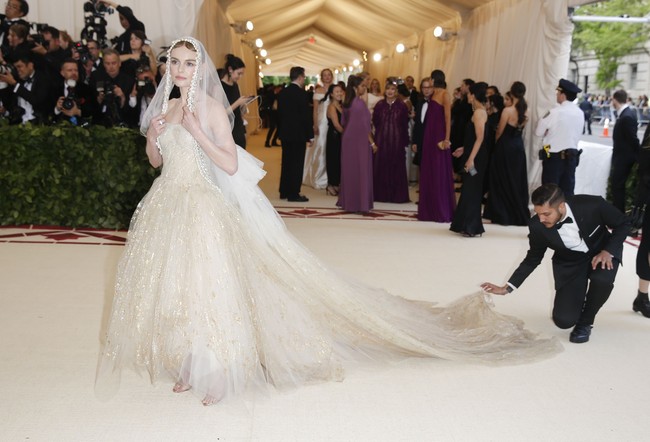 MET Gala merupakan ajang yang digelar untuk menggalang dana amal bagi museum sekaligus merayakan pembukaan pameran tahunannya. Di bawah tema yang sama, pameran MET Gala akan menampilkan busana-busana sakral dari Vatikan yang pernah dipakai Paus, seperti jubah berhiaskan bordiran emas milik Paus Benedict XV dan topi Paus Leo XIII. Koleksi tersebut nantinya akan bersandingan dengan busana-busana karya Coco Chanel, yang diketahui pernah dididik oleh suster, Balenciaga, hingga Donatella Versace selaku pihak sponsor.  Foto: Dok. Reuters, Getty Images