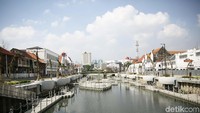 Para pekerja proyek mengerjakan beberapa pekerjaan yang belum tuntas, seperti memasang lampu penerangan. Pasir dan batu sisa proyek juga tampak belum dibersihkan.