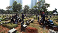 Mereka tampak khusyuk berdoa kemudian menabur kembang di atas kuburan.