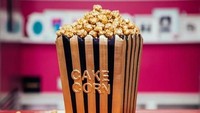 Kue bentuk popcorn emas ini memang bertopping popcorn sungguhan. Hanya saja sudah diberi pewarna emas. Namun, tempat popcorn tersebut merupakan kue cokelat. Foto: Instagram @yolanda_gampp