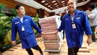 Tumpukan uang tersebut tiba dengan dikawal oleh beberapa petugas kepolisian dan petugas Bank Mandiri.