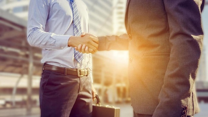 Success and Happiness concept, Business man handshake at city outside office.