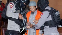 Ketua ISIS Indonesia ini hadir diruang sidang dengan tangan terborgol dan mengenakan baju tahanan berwarna oranye.