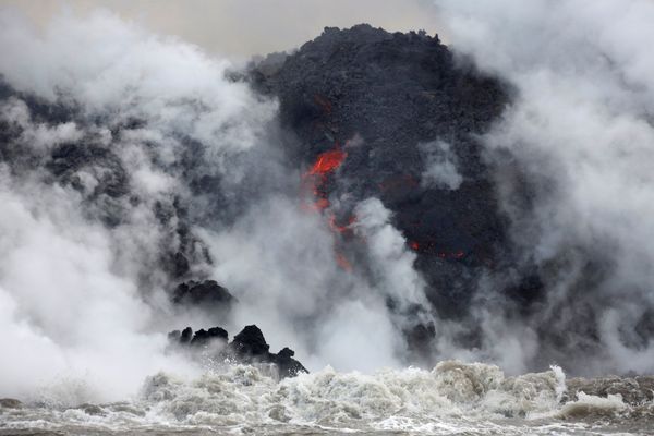 Lava flows into the Pacific Ocean southeast of Pahoa during ongoing eruptions of the Kilauea Volcano in Hawaii, U.S., May 20, 2018.   REUTERS/Terray Sylvester
