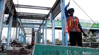 Petugas tengah memindahkan material bangunan dari halte TransJakarta BNN di kawasan Cawang, Jakarta, Selasa (22/5/2018).